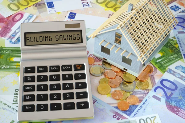 The Words Building savings on Calculator display — Stok fotoğraf