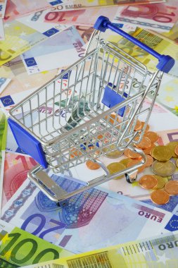 Blue shopping cart on money