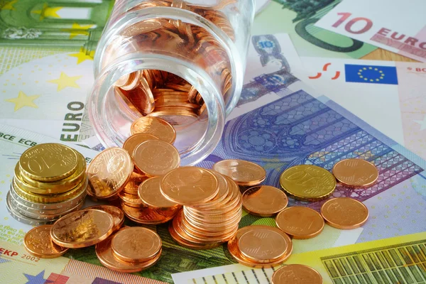 Small glass with coins — Stock Photo, Image