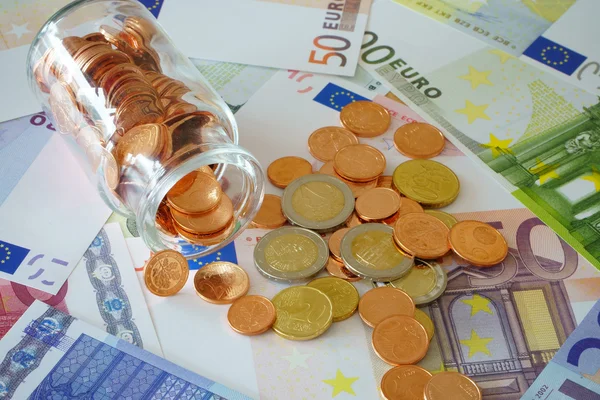 Small glass with coins — Stock Photo, Image