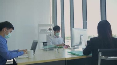 4k Kararlılığın iş konsepti. Çalışanlar maske takarak çalışırken kendilerini koruyorlar..