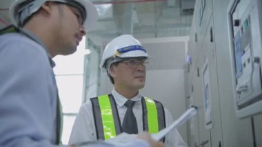 Mühendislik konsepti 4k Çözünürlük. Teknisyen takım liderini bir iletişim cihazıyla koordine ediyor..