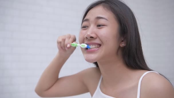 Daily routine concept of 4k Resolution. Asian woman brushing teeth in the bathroom.