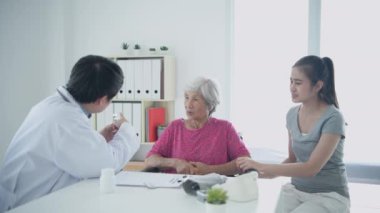 4k çözünürlüğünün tıbbi konsepti. Bir doktor hastane odasında bir hastaya ilacı açıklıyor..