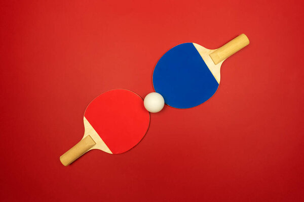 Two table tennis rackets lie opposite to each other ready for the ping-pong competitions