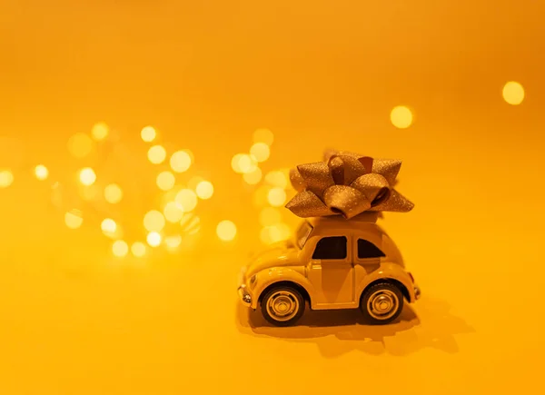 Yellow Mini Car Golden Bow Its Top Bokeh Lights Yellow — Stock Photo, Image