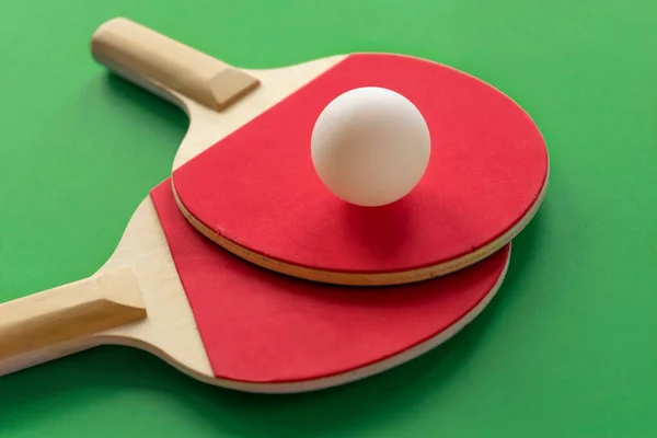 Two table tennis rackets lie opposite to each other ready for the ping-pong competitions