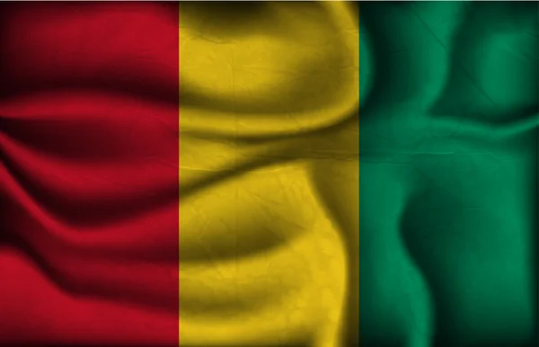 Bandera arrugada de Guinea sobre un fondo claro — Vector de stock