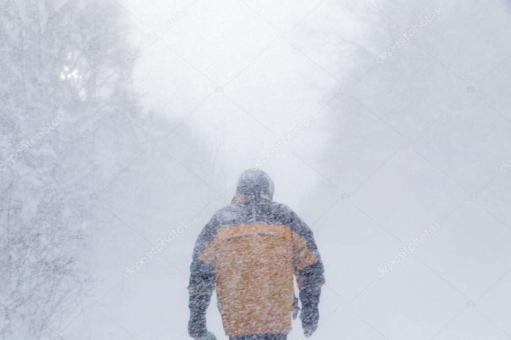 Man walking in heavy snow storm