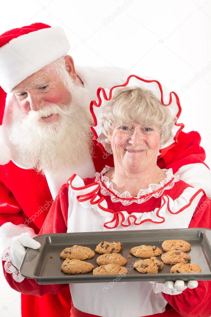 Santa claus and Mrs Santa with cookies