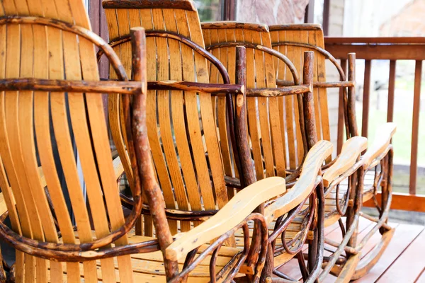 Rustic rockers in a row — Stock Photo, Image