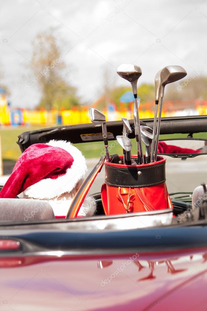 Santa in convertible with golf clubs
