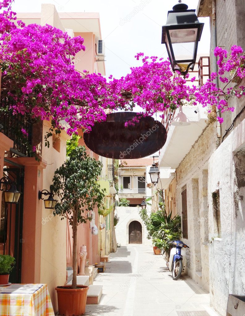 traditional street amoung bougainvillaea in rethymno city Greece