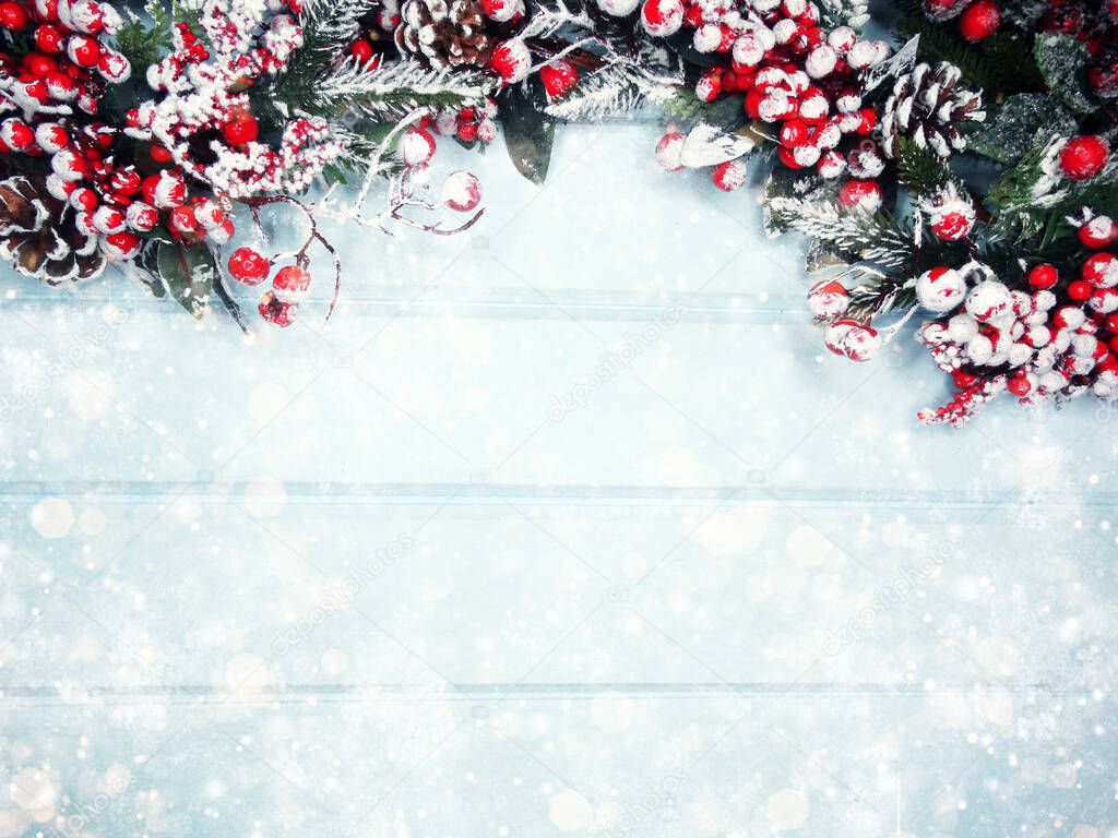 winter christmas background with fir branches cones and snow on blue wooden texture                              