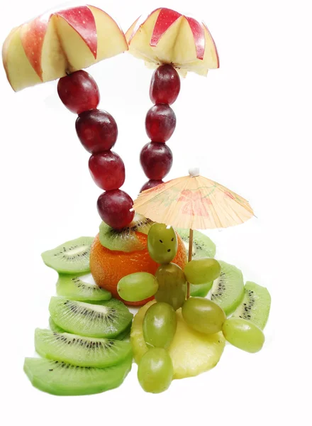 Creative fruit child dessert man sunbathing on the beach — Stock Photo, Image