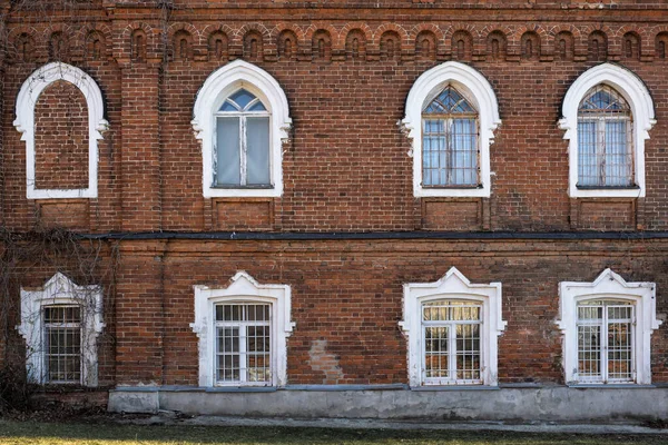 Vintage gothic architecture classical red brick facade building lancet windows front view