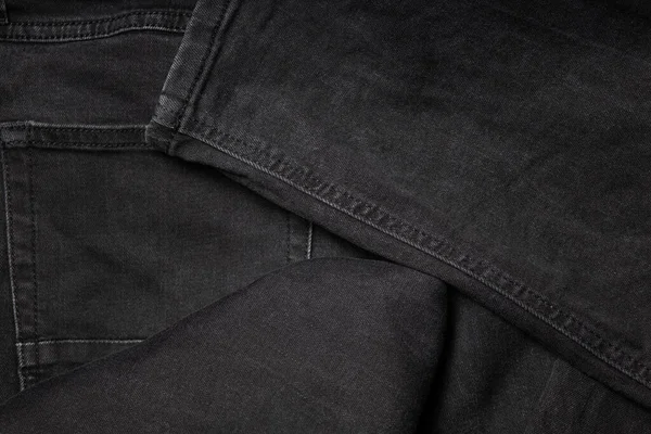 Brand new black jeans textile. Jeans macro texture background — Stock Photo, Image