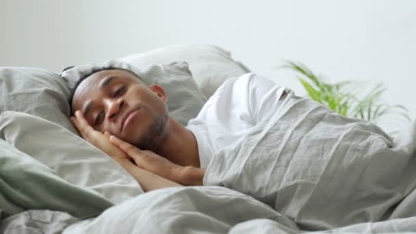 Jonge Afrikaans-Amerikaanse man die thuis in bed slaapt — Stockvideo