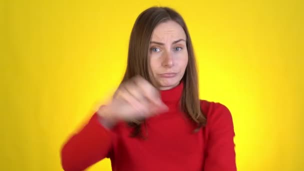 Displeased worried young woman posing isolated on yellow background studio. Say no showing stop gesture with palm crossed hands — Stock Video