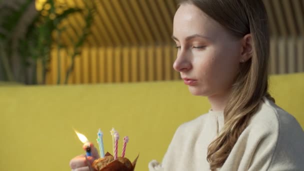 Mujer enciende una vela en un delicioso pastel — Vídeo de stock