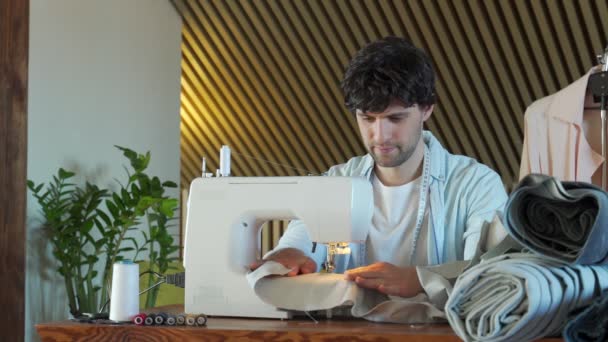 El diseñador de ropa a la moda cose en la máquina de coser. Diseñador de moda trabajando en su estudio — Vídeos de Stock