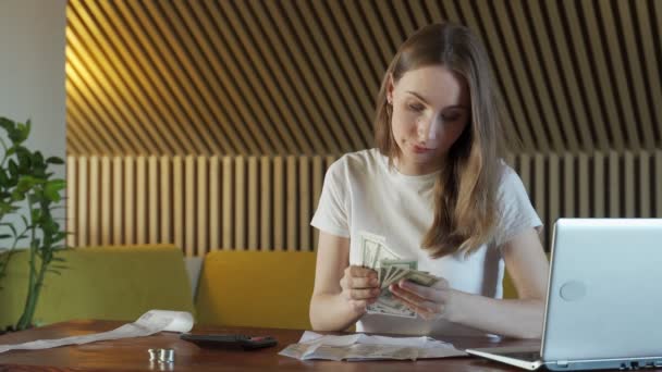 Woman with calculator counting dollar money at home — Stock Video