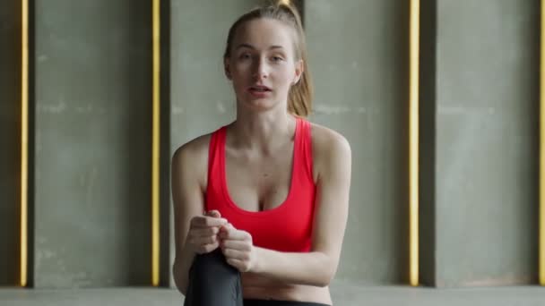 Fitness vlogger nagrywanie wideo na żywo samouczek. Sportowiec siedzi na macie, patrzy w kamerę i opowiada o celach treningowych — Wideo stockowe