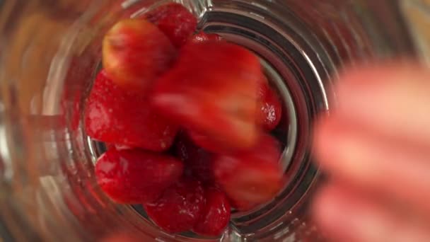 Fresas maduras rojas dulces caen en la licuadora y vierten yogur. Vista superior. — Vídeos de Stock