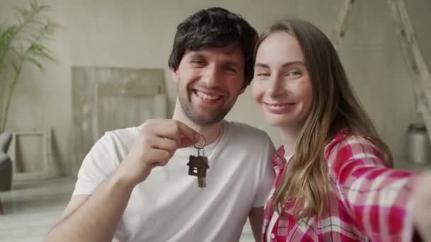 Familjepar visar stolt upp nycklarna till sitt nya hem — Stockvideo