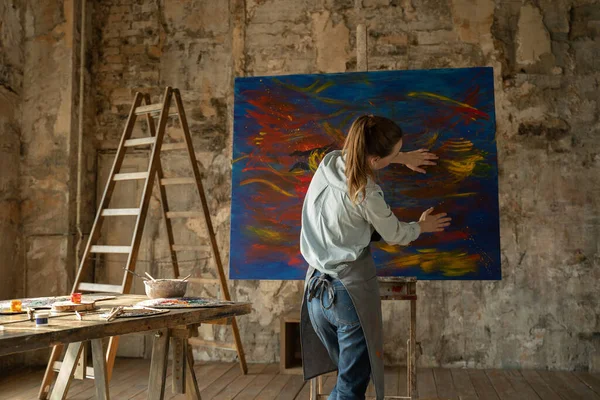 Artista femminile disegna con le mani sulla grande tela crea pittura a olio. Pittore che crea arte astratta — Foto Stock