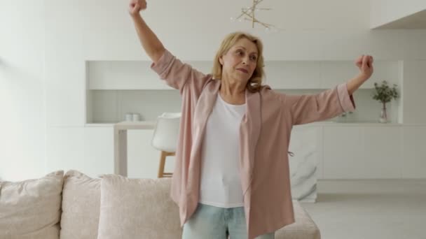 Une femme âgée active qui fait du pilates à la maison, s'entraîne dans le salon — Video