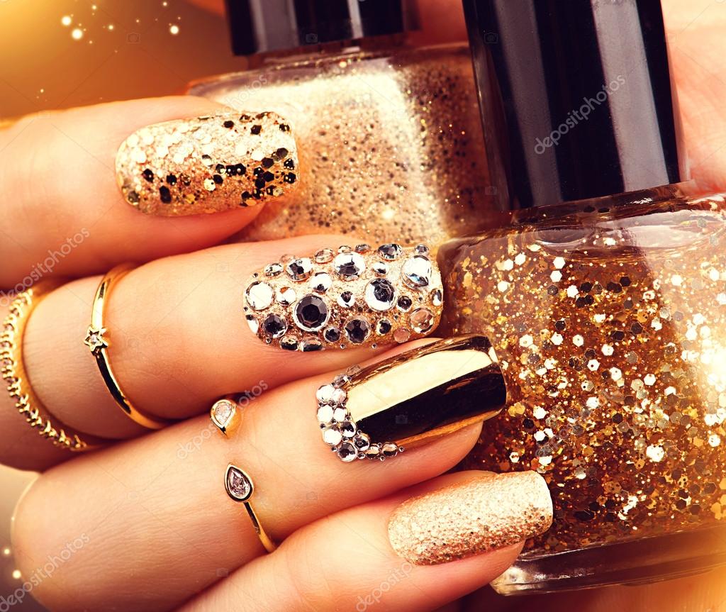 Golden manicure with gems and sparkles. Stock Photo by ©Subbotina 100196828