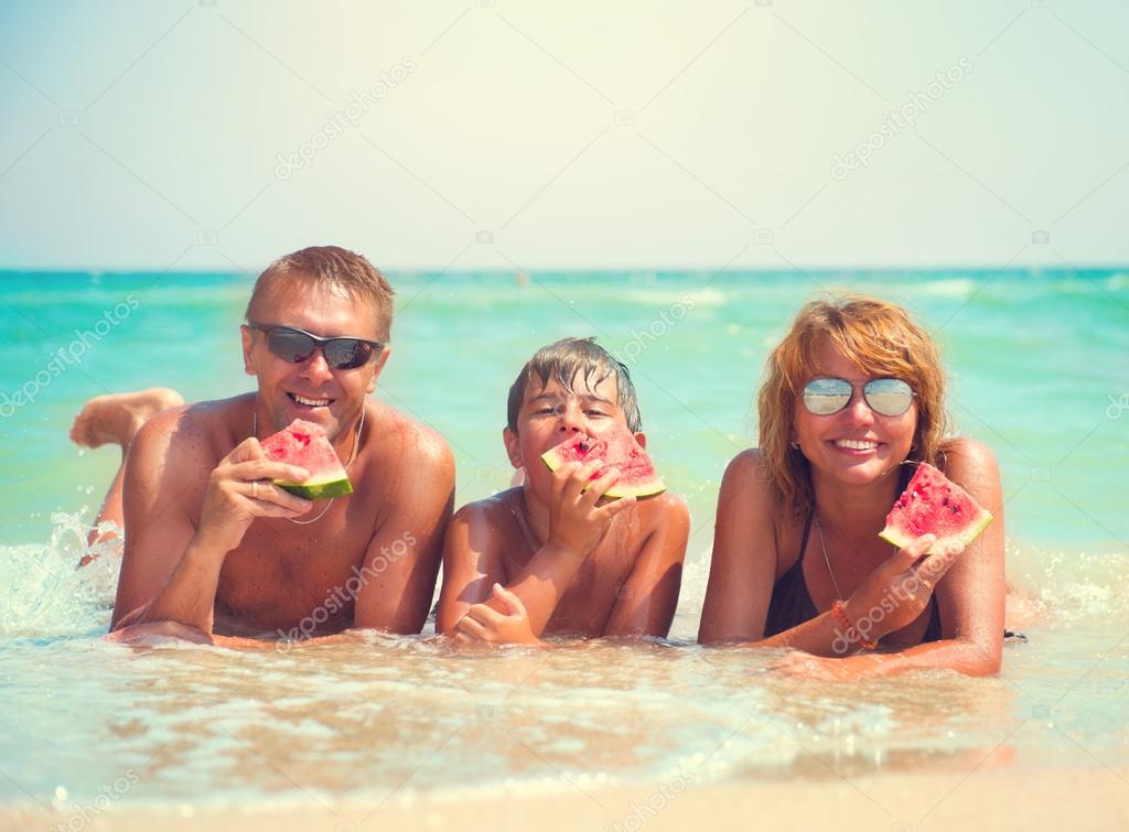 young family eating fresh  watermelon