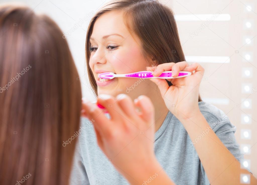 Young woman brushing her teeth.