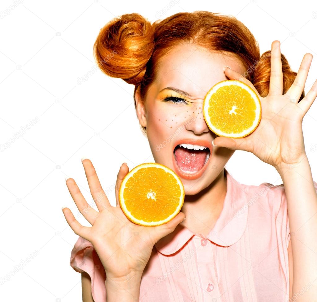 Joyful teen girl with oranges