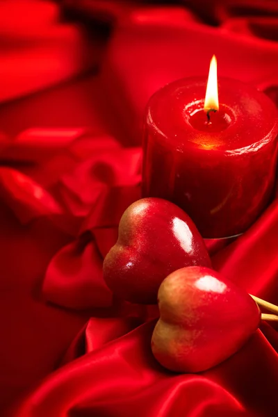 Valentine red hearts and candle — Stock Photo, Image