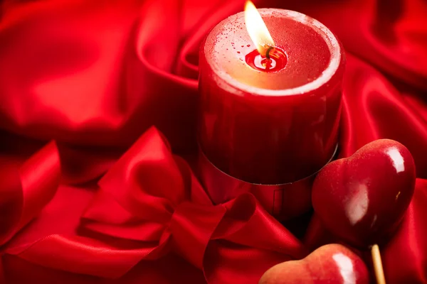 Valentine red hearts and candle — Stock Photo, Image