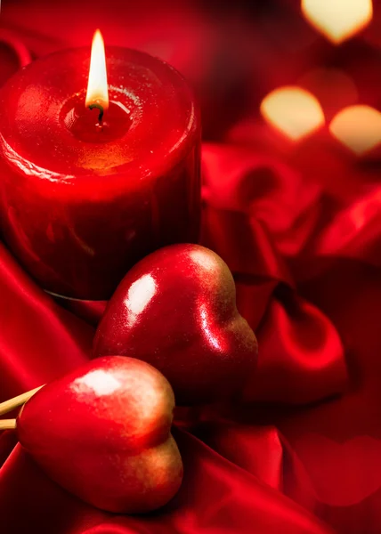 Valentine red hearts and candle — Stock Photo, Image