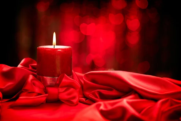 Valentine red candle on red silk — Stock Photo, Image