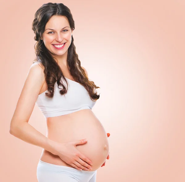 Pregnant woman holding her  belly — Stock Photo, Image