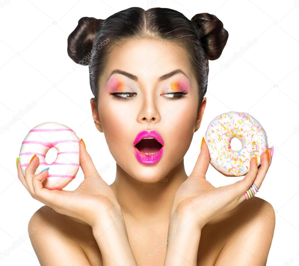 girl taking colorful donuts.