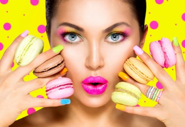 Girl with colorful makeup and macaroons