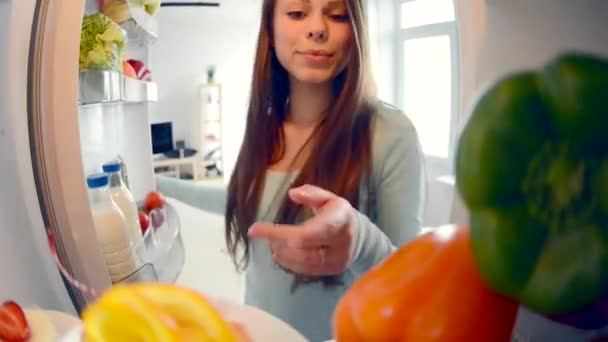 Cute pretty teenage girls in the kitchen next to fridge — Stock Video