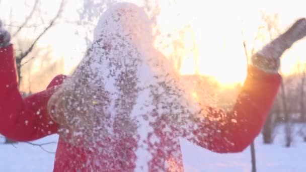 Teenage girl throws snow up — Stock Video