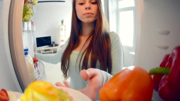 Cute pretty teenage girls in the kitchen next to fridge — Stock Video