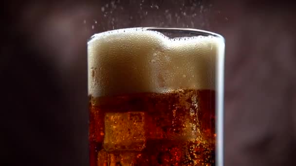 Cola with ice and bubbles in glass — Stock Video