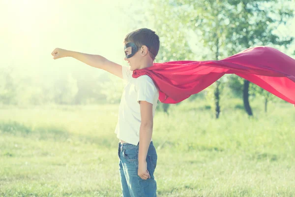 Little boy wearing superhero costume