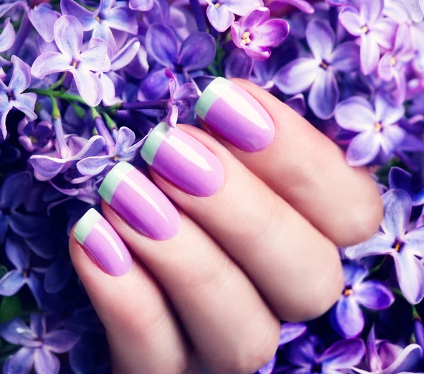 Violet with green manicure with lilac flowers