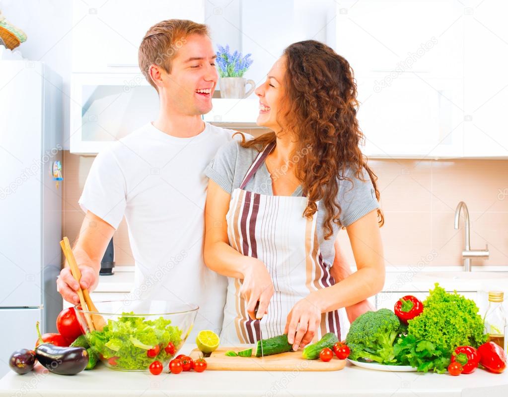 couple cooking together in kitchen
