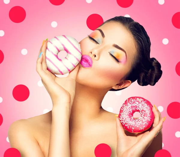 Woman holding colorful donuts — Stock Photo, Image